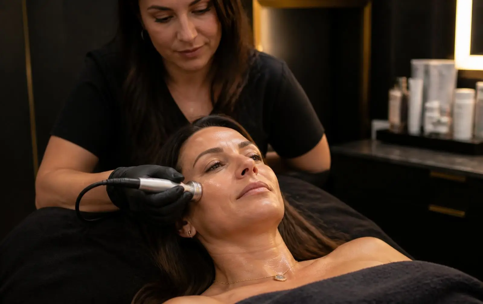 Woman in her forties receiving an anti-aging skin rejuvenation treatment at Opteluxe Wellness med spa in Mooresville, NC